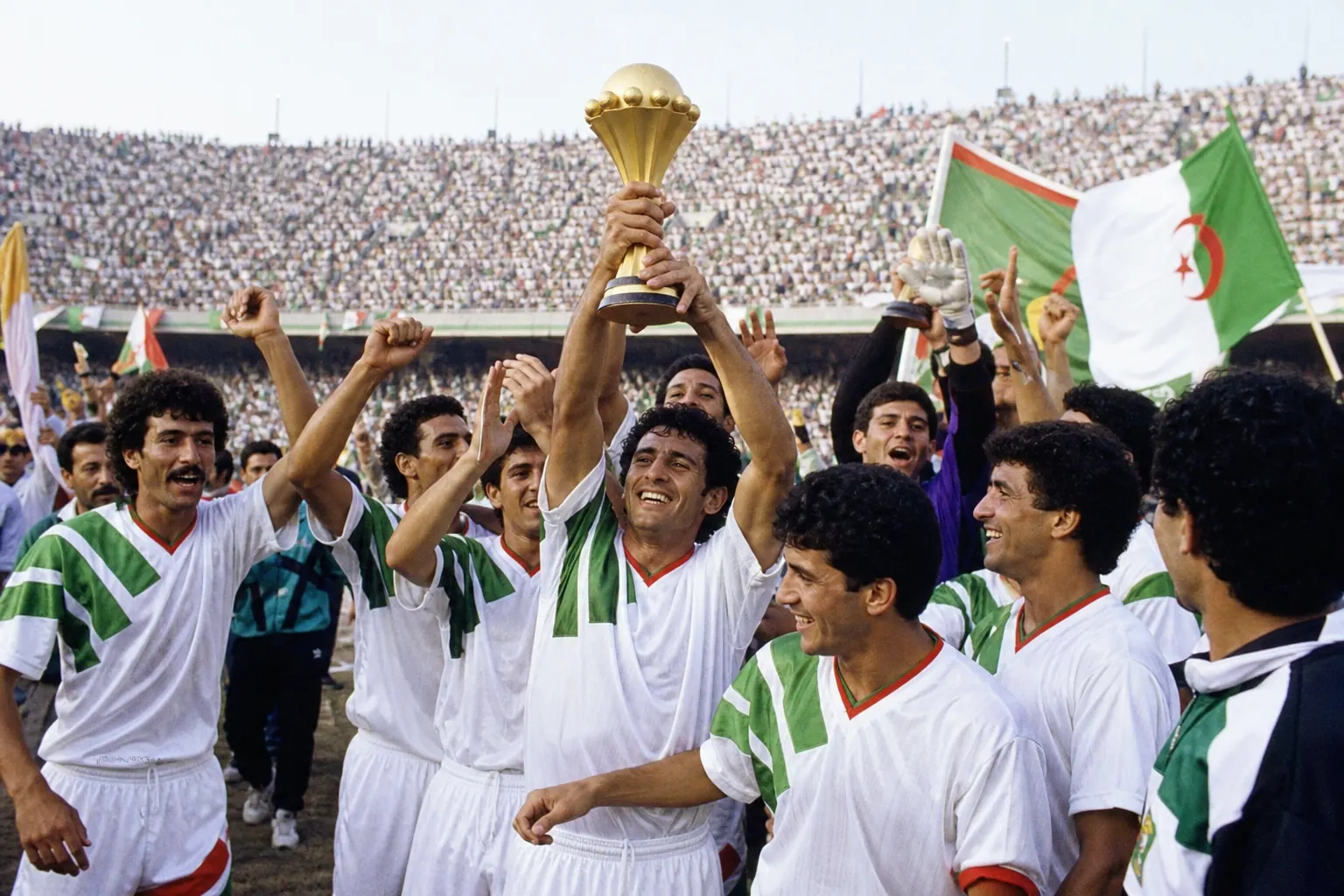 Fictional Algerian footballers lifting the Africa Cup of Nations trophy after winning AFCON 1990 at home