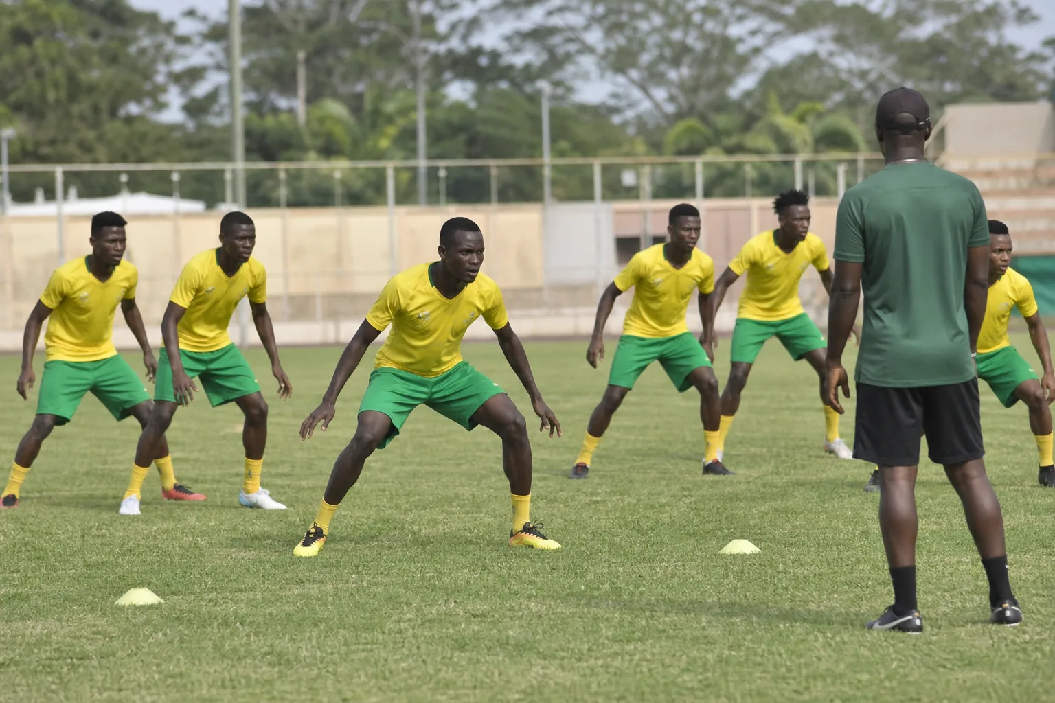 Benin national-team players holding a disciplined defensive shape in training