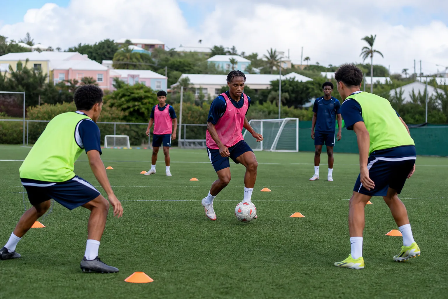 Bermuda national-team players training on a compact island football ground