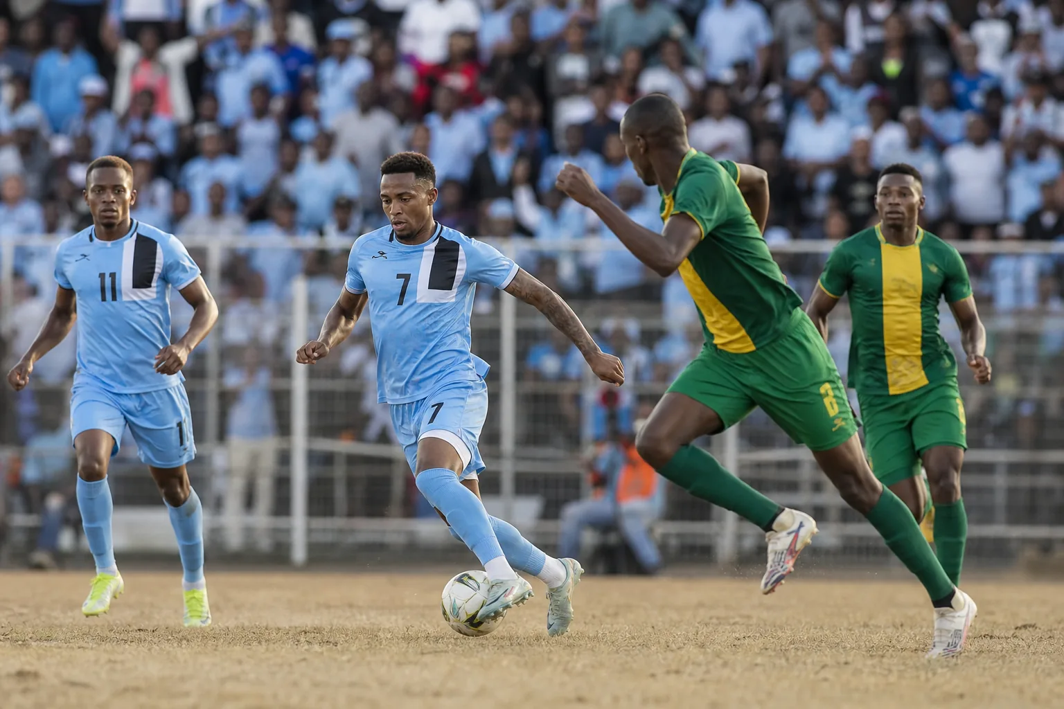 Botswana players competing in a tense Africa Cup of Nations group-stage match under stadium lights