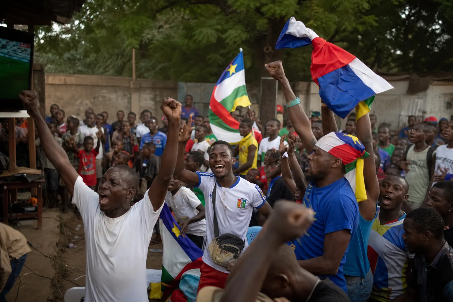 Central African Republic football supporters celebrating around a community viewing area in Bangui