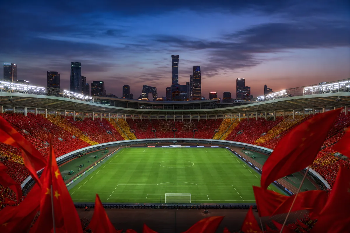 A Beijing football stadium-inspired ground prepared for an Asian Cup match with red-and-gold flags