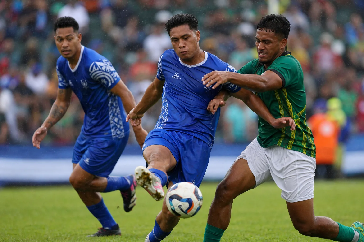 Cook Islands players competing in an intense OFC qualifying match against Pacific island opponents