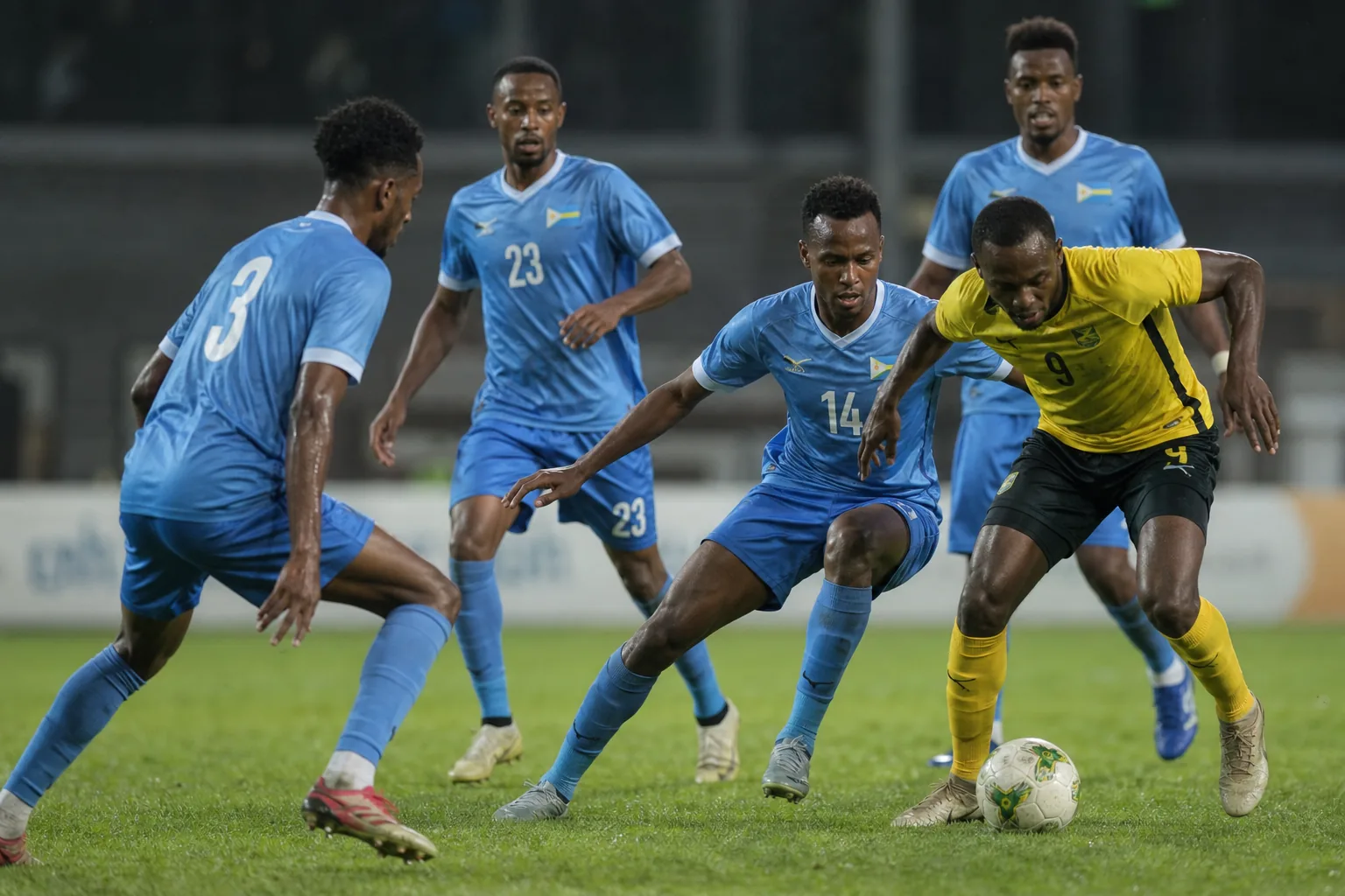 Djibouti football supporters and players connected through a community match in a compact stadium