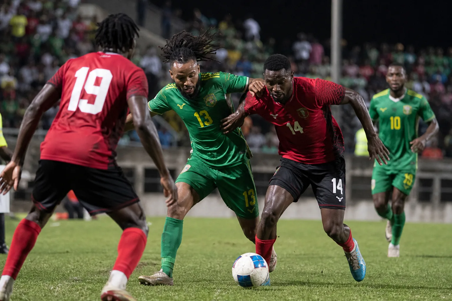 Dominica football supporters and community players gathered around a match in Roseau