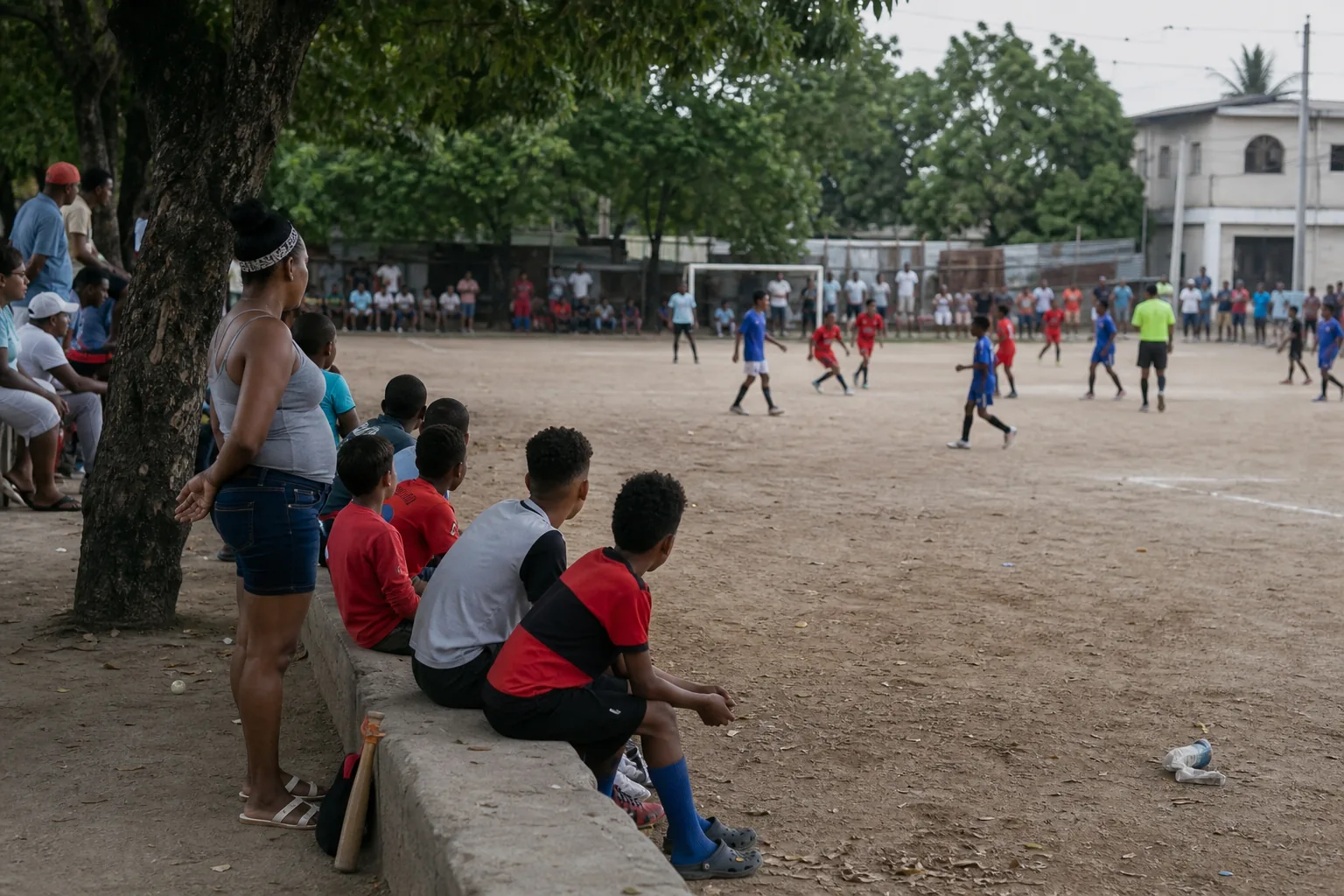 Young Dominican footballers and families gathered around a community match in Santo Domingo