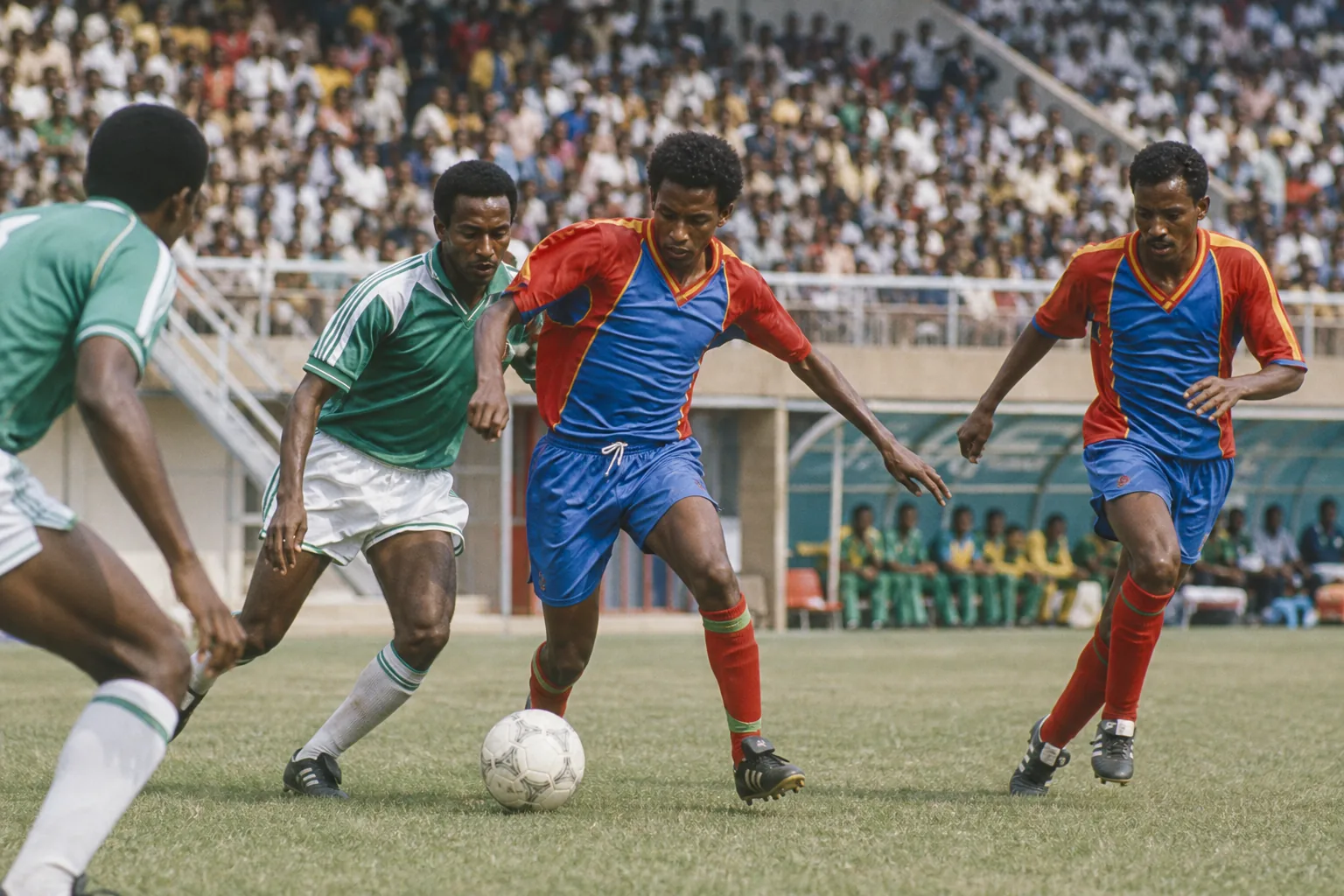 Eritrea national football team preparing together in red-blue kits on an Asmara football ground