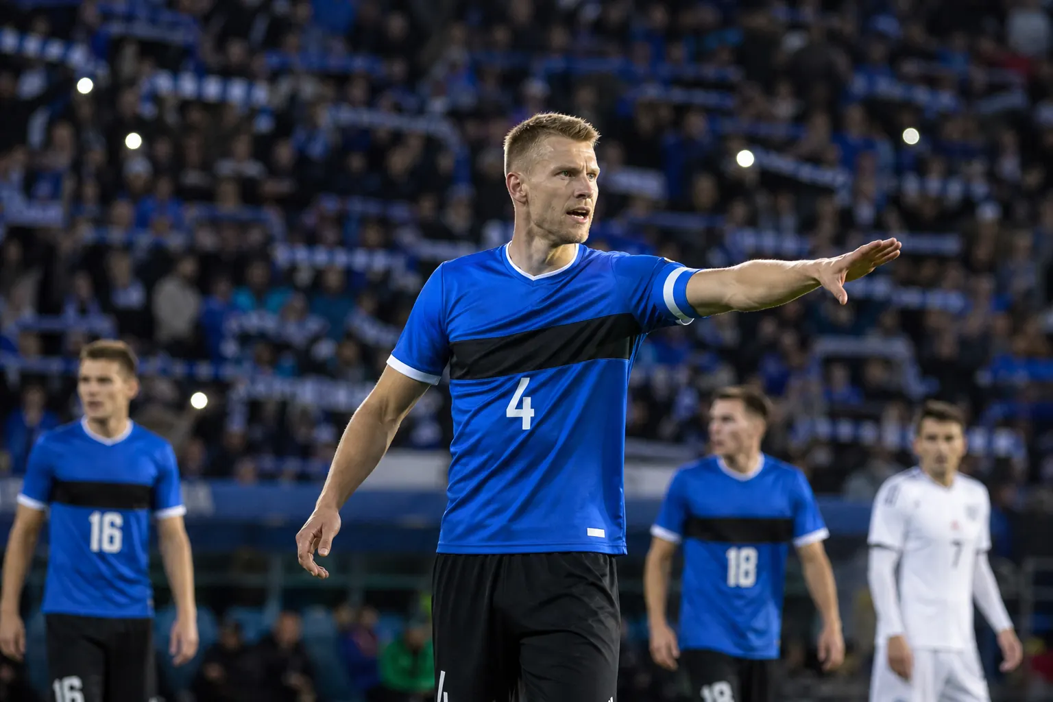 A fictional Estonian national-team star captain leading from central defence in an international match