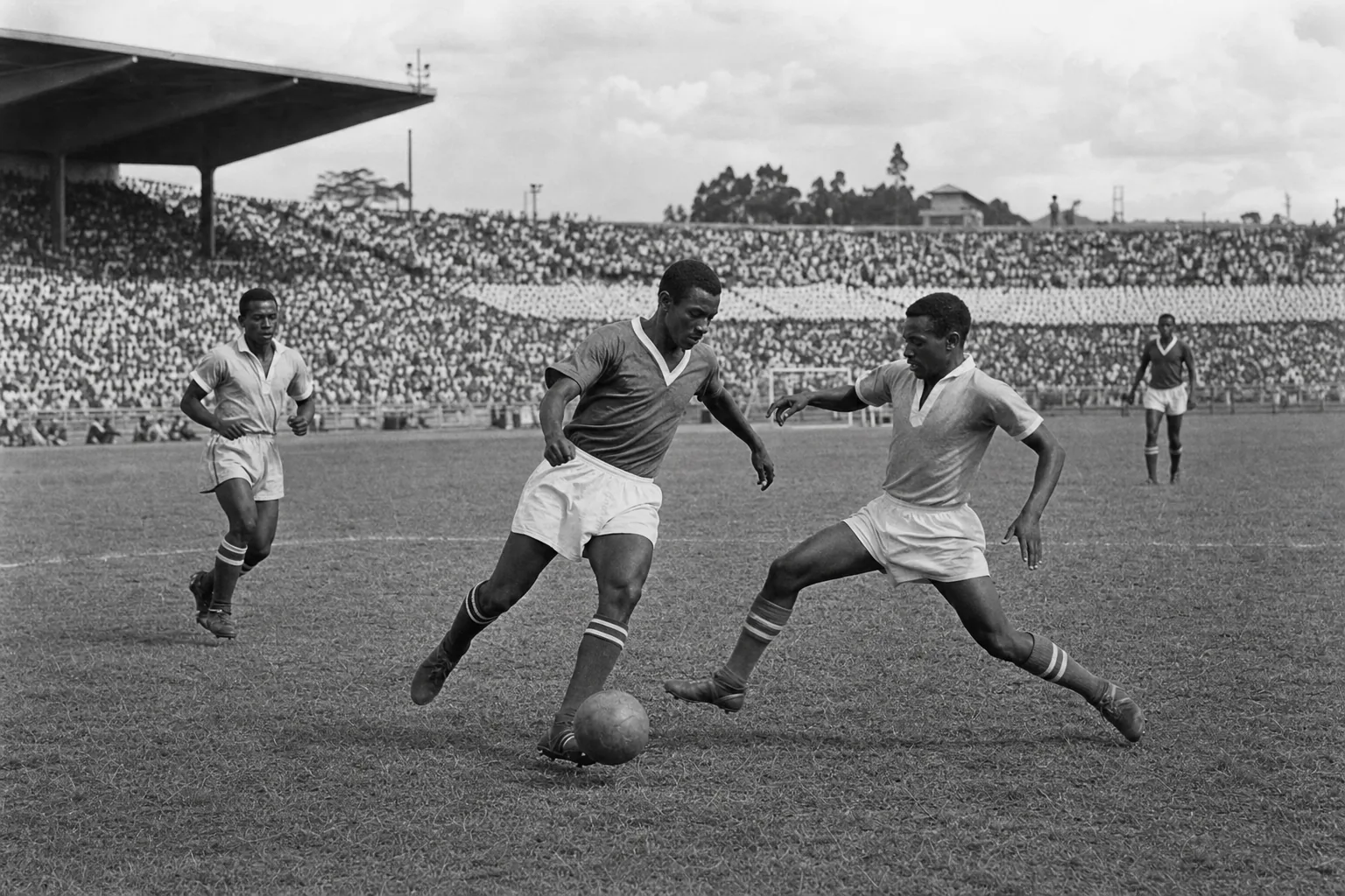 Ethiopia national football team preparing together in green-yellow-red kits on an Addis Ababa football ground