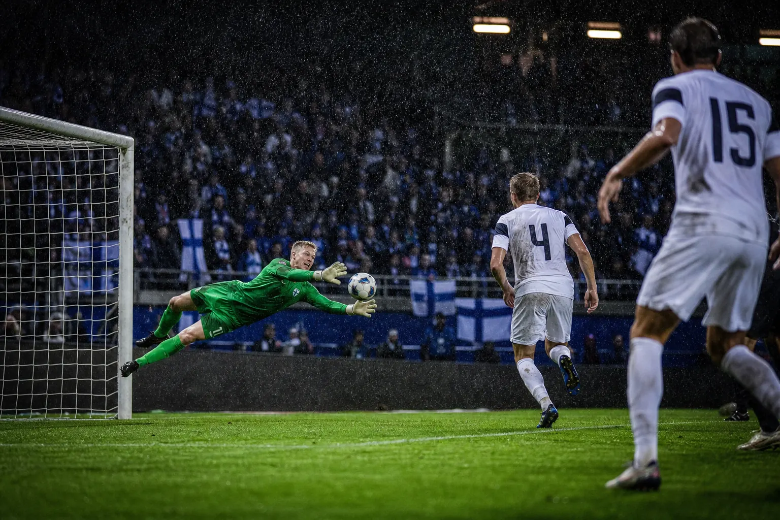 A fictional Finnish goalkeeper making a crucial late save in a rainy European qualifier