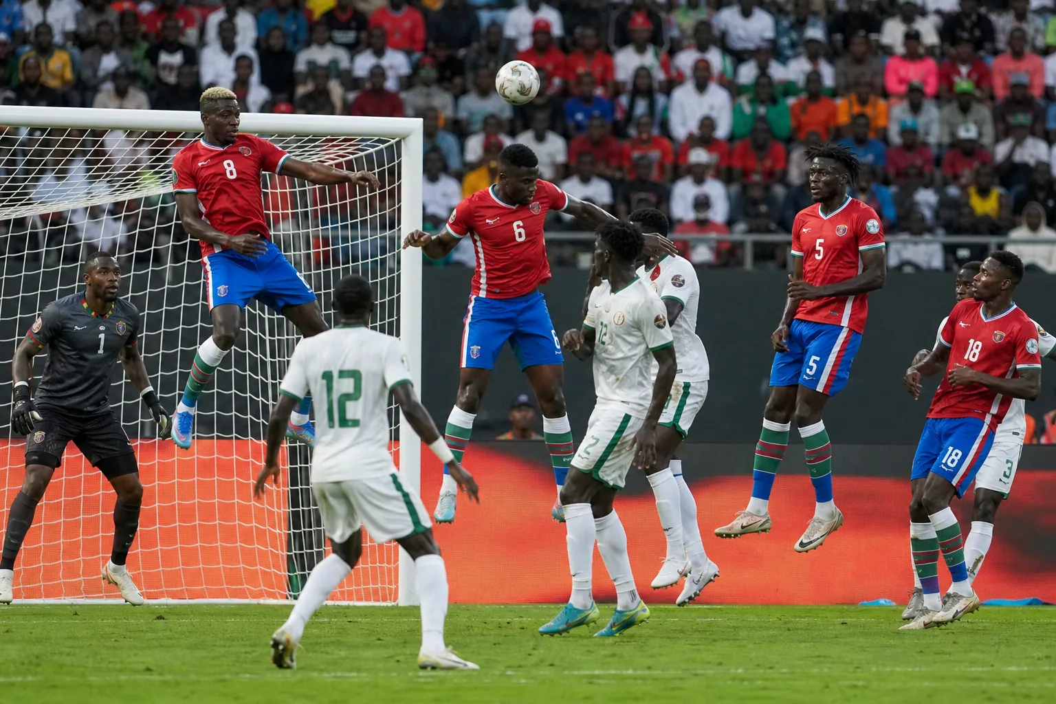 Gambia players defending compactly and preparing a quick counterattack in an AFCON match