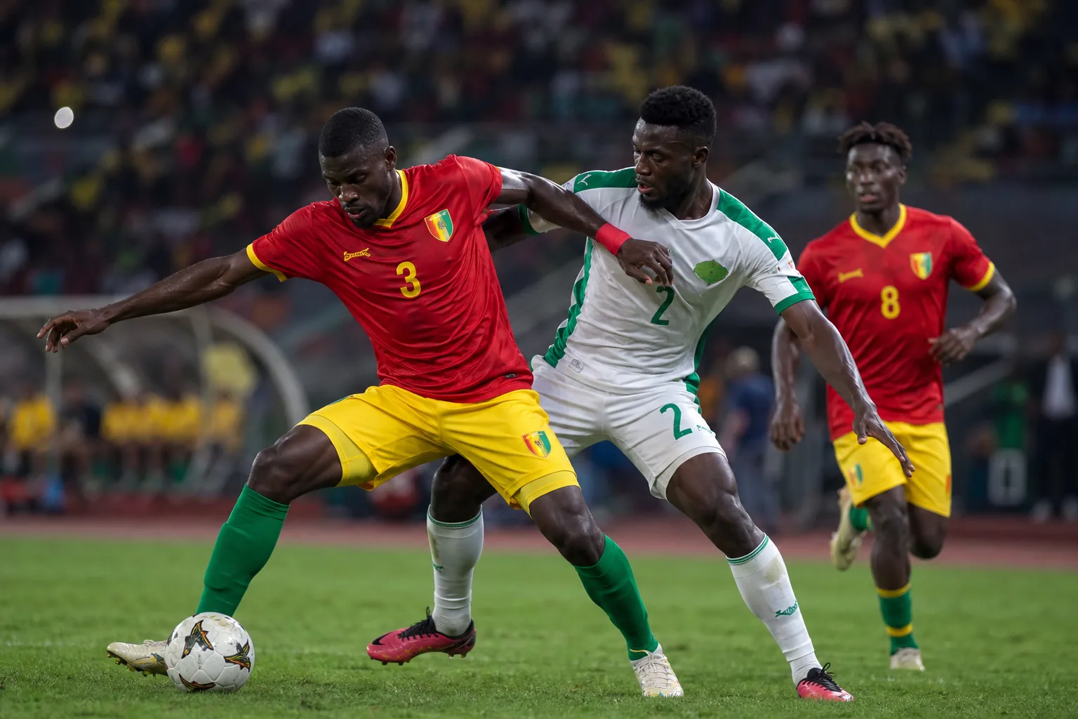 Modern Guinea players celebrating a dramatic AFCON knockout-stage victory before passionate supporters