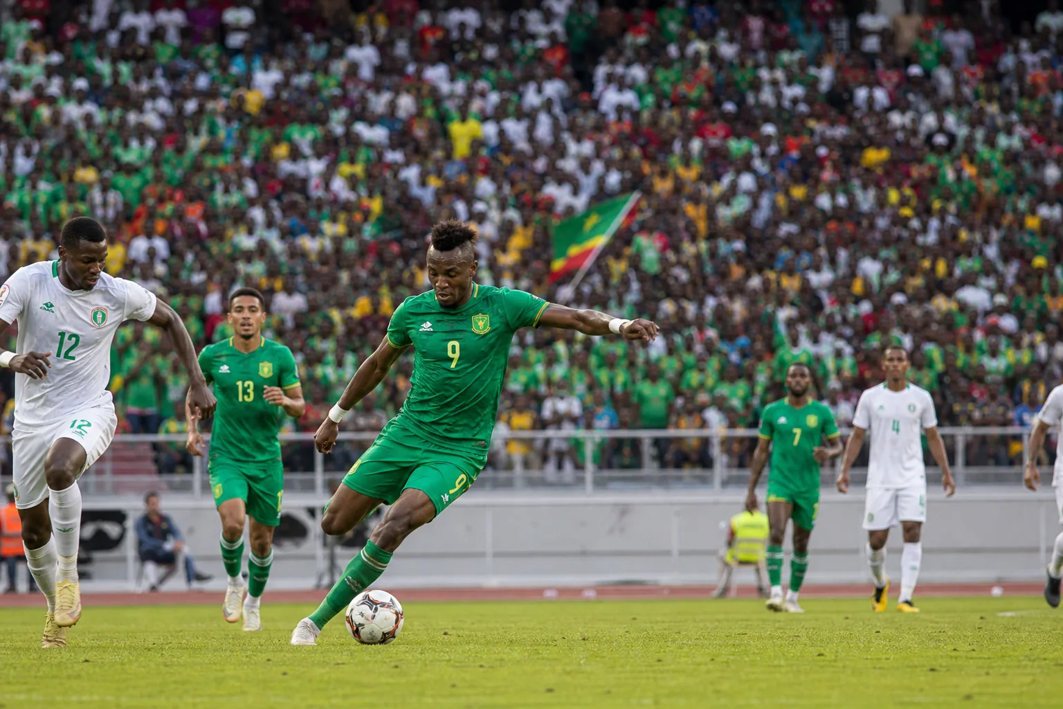 Mauritania contesting a high-pressure African tournament match in front of a packed crowd
