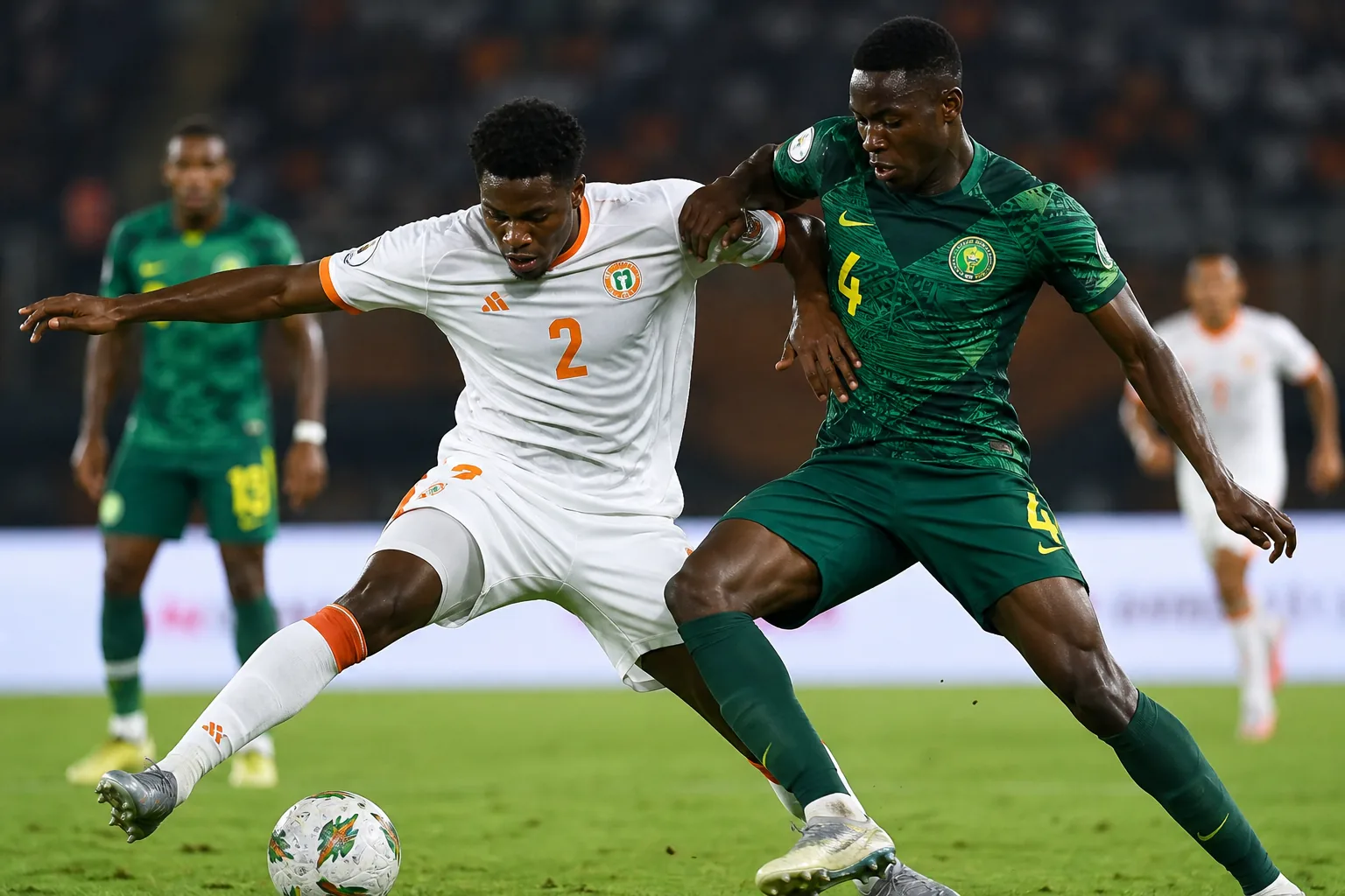 Niger Mena preparing together for an AFCON qualifier in white-and-orange kits on a Sahel training ground