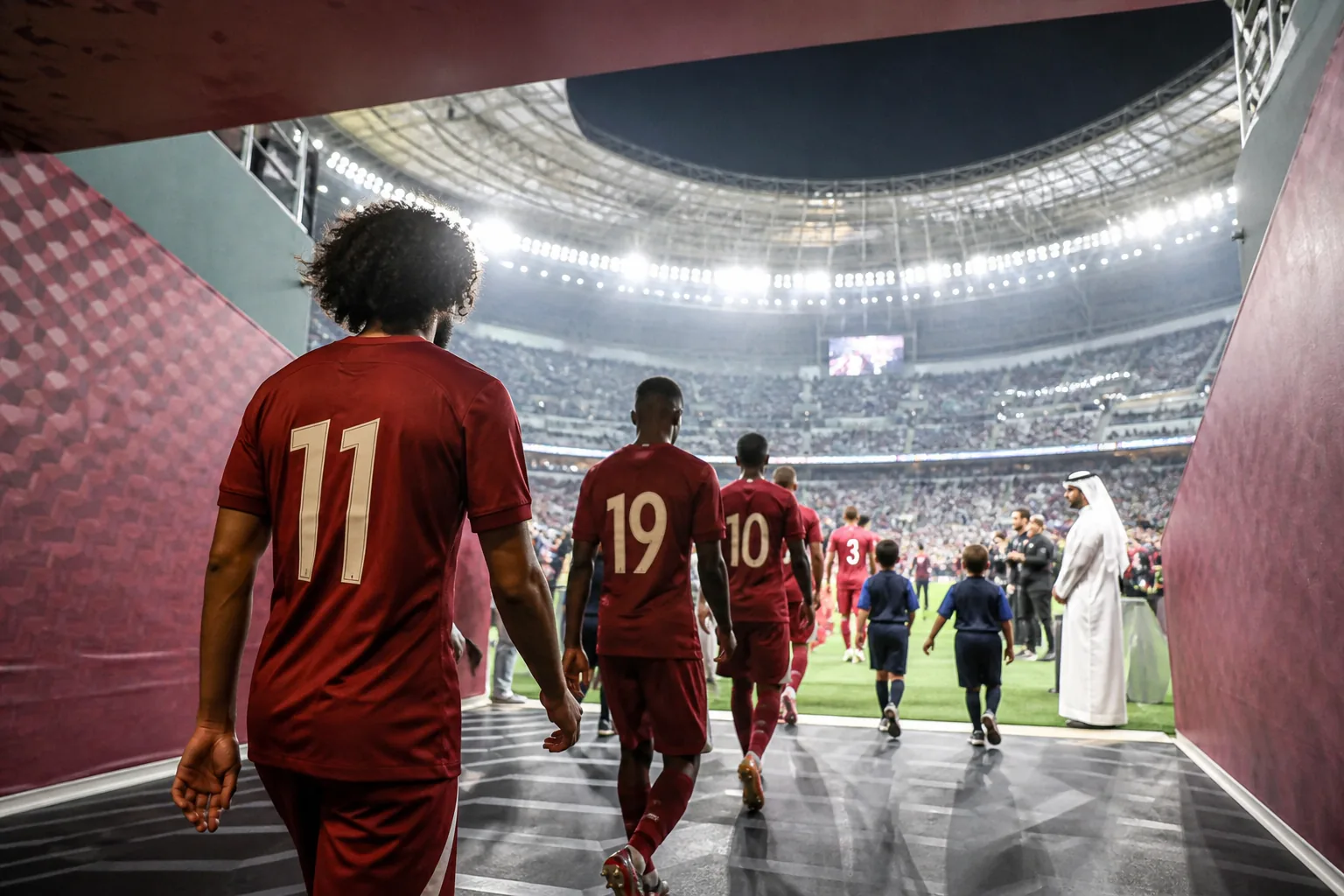 Qatar national team preparing together in maroon kits before a major Asian Cup match in Doha