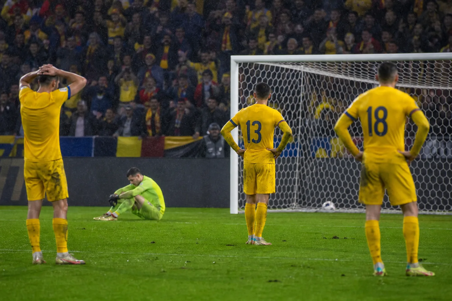 Fictional Romanian players reacting after a heartbreaking knockout penalty shootout
