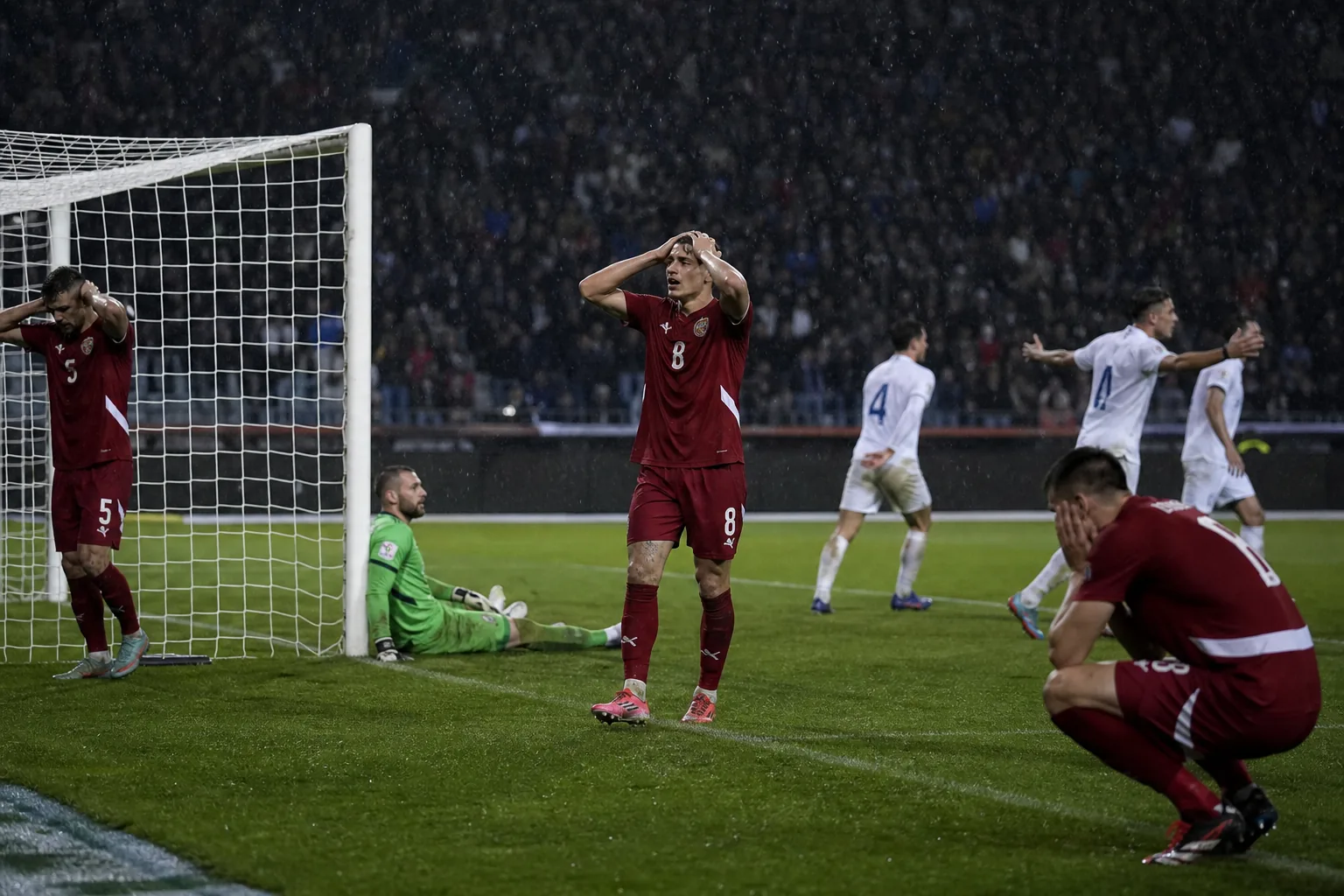 A fictional Serbian national-team star striker powering a shot toward goal