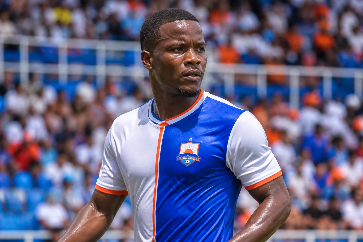 A fictional editorial portrait inspired by Sint Maarten footballer Gerwin Lake in a blue-and-white national-team kit