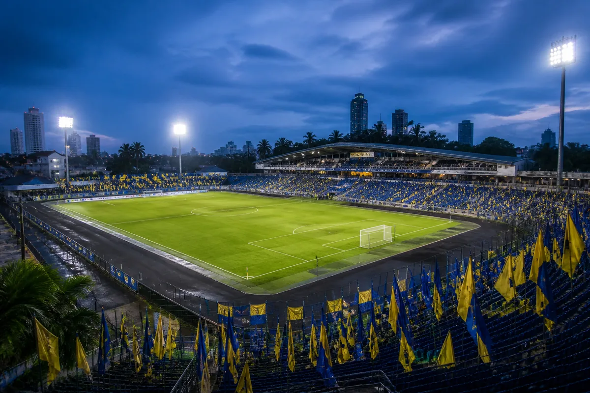 A Colombo football stadium-inspired ground prepared for a South Asian match among tropical palms