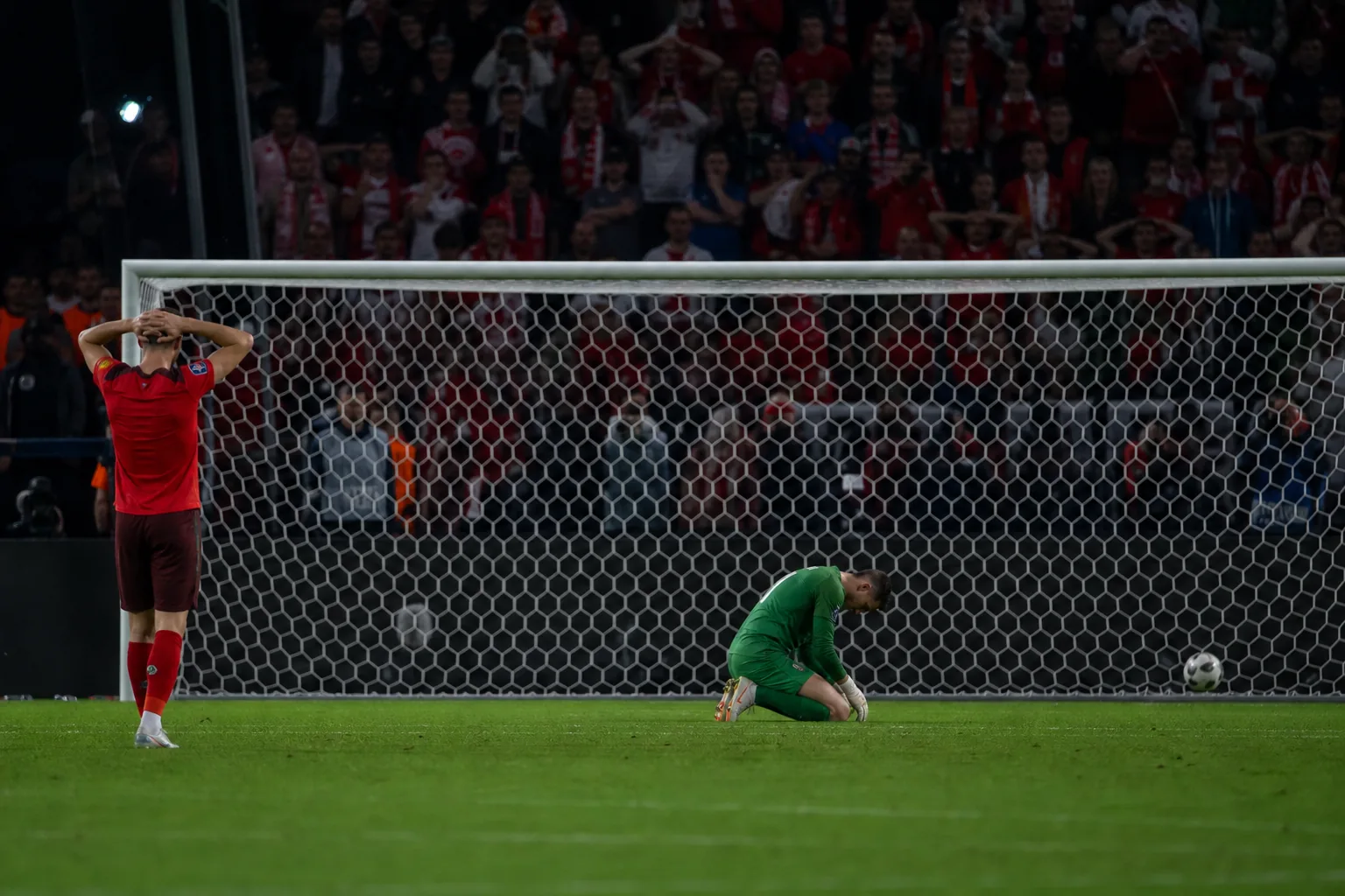 Fictional Swiss players reacting after a dramatic penalty shootout defeat