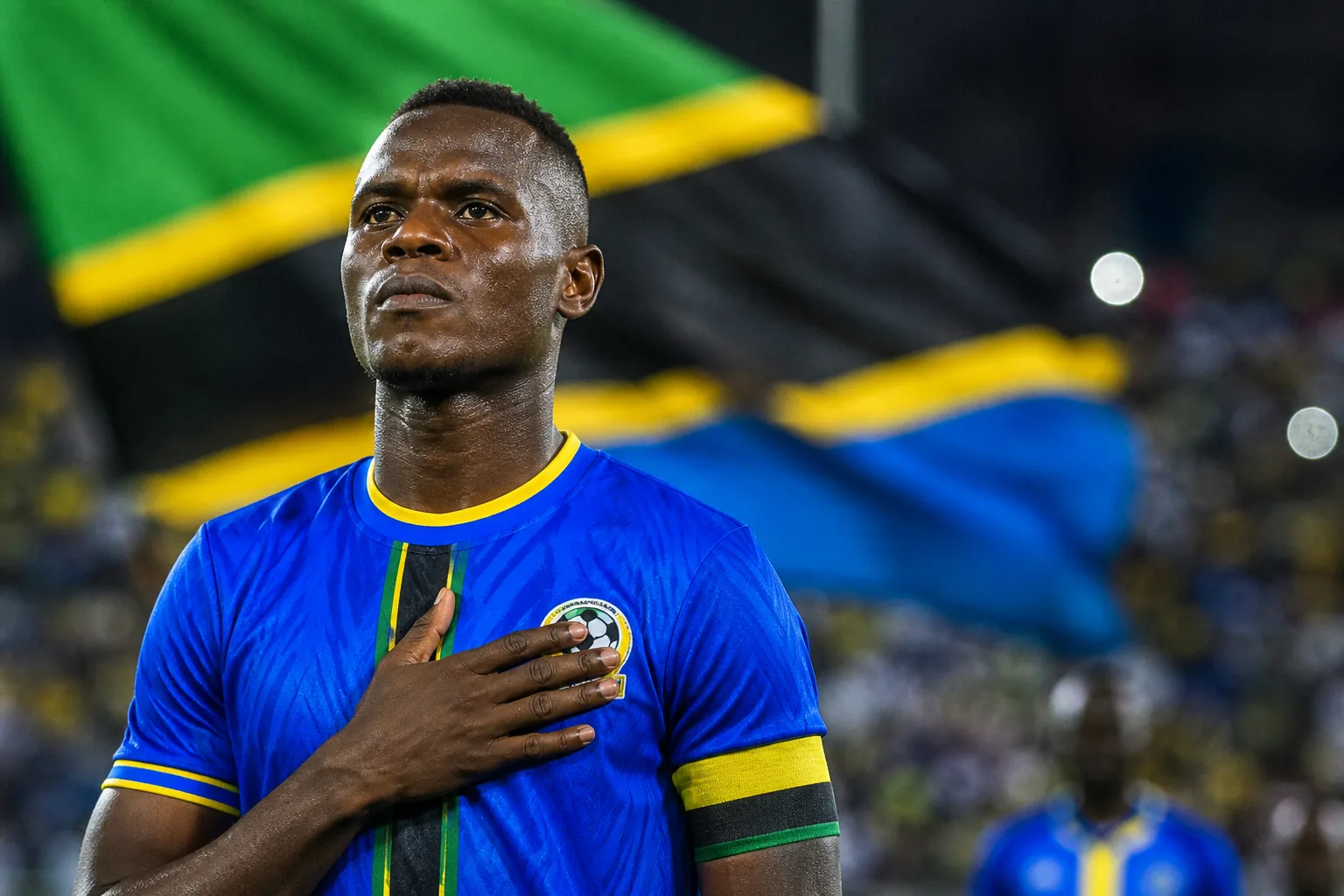 A fictional editorial portrait inspired by Tanzania captain Mbwana Samatta in a blue Taifa Stars kit