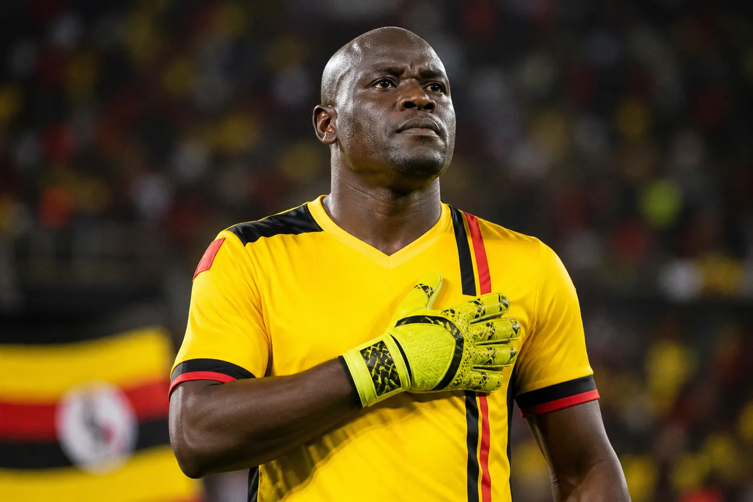 A fictional editorial portrait inspired by Uganda goalkeeper Denis Onyango in a yellow Cranes kit