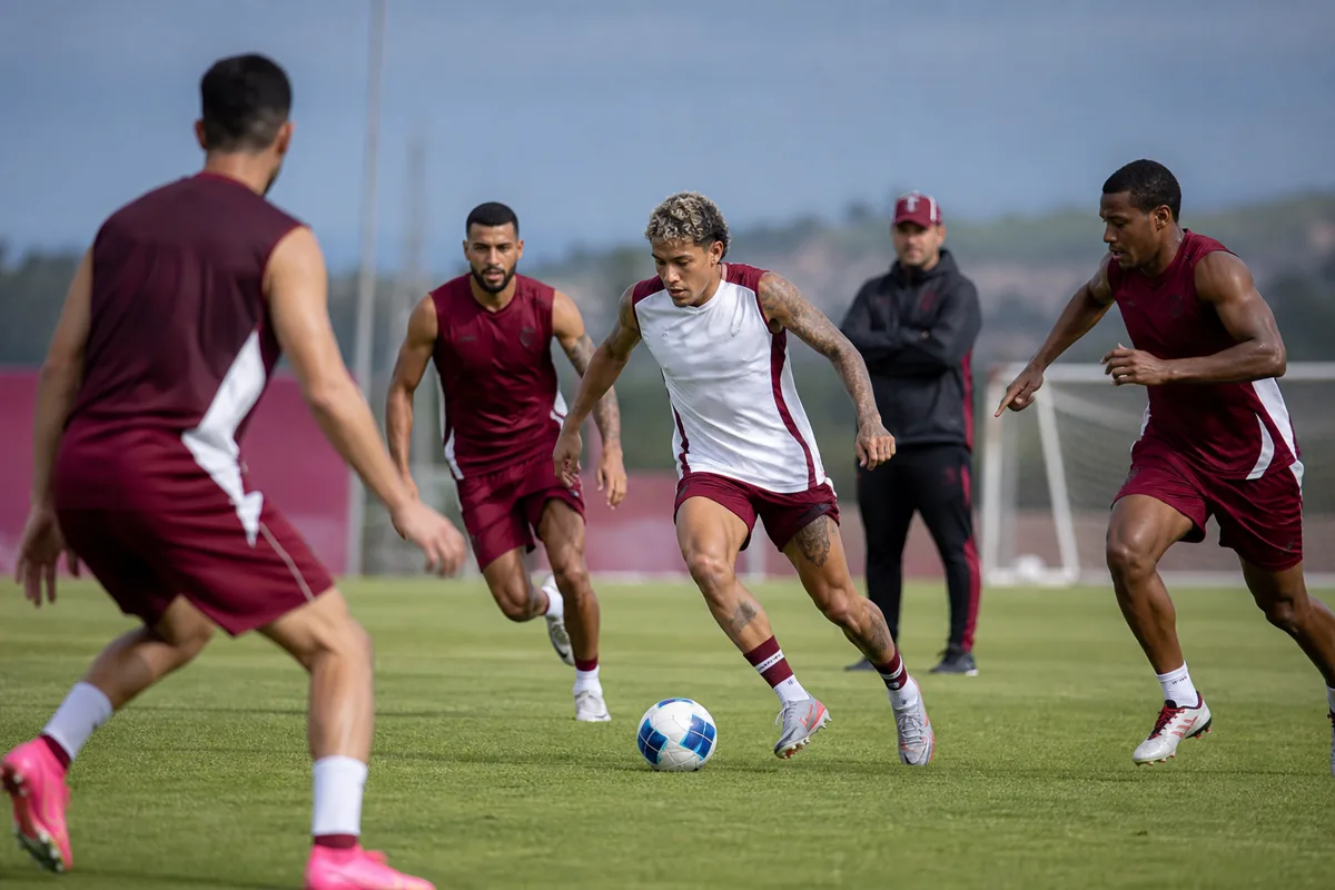 Fictional Venezuela national-team players practicing a fast transition drill while an attacking player drives through midfield